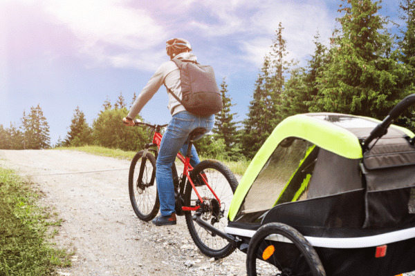 child's bike trailer being towed by electric bike